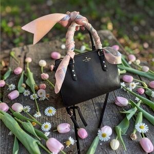 kate spade black leather satchel with pink scarf-wrapped handle